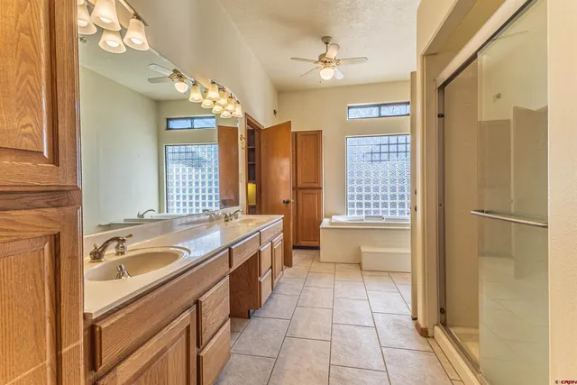 an empty room with a window and a ceiling fan