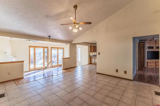 a view of a kitchen with furniture and a ceiling fan