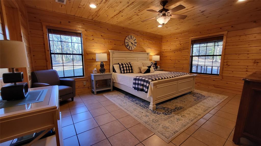 9 Private Road Leesburg, TX 75451 - Photo 14 of 26 a bedroom with furniture and a large window