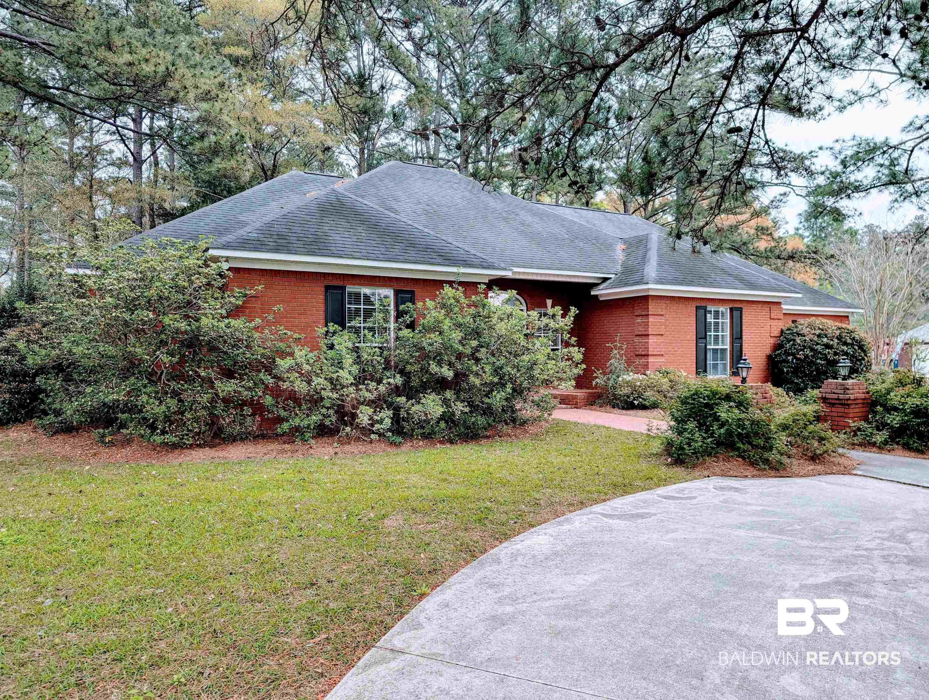 506 Old Castleberry Road Brewton, AL 36426 - Photo 3 of 14 View of home's exterior with brick siding, roof with shingles, and a yard