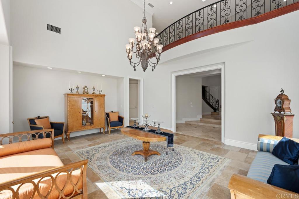 6773 Poco Lago Rancho Santa Fe, CA 92067 - Photo 15 of 65 a living room with furniture and a chandelier