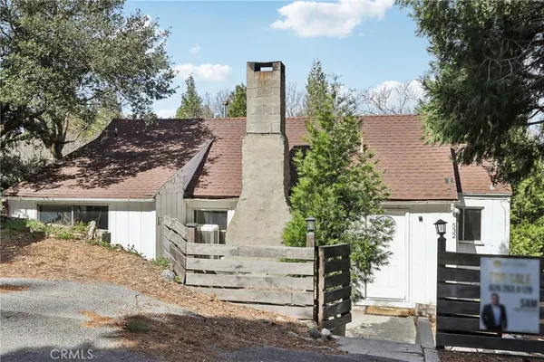 front view of a house with a tree