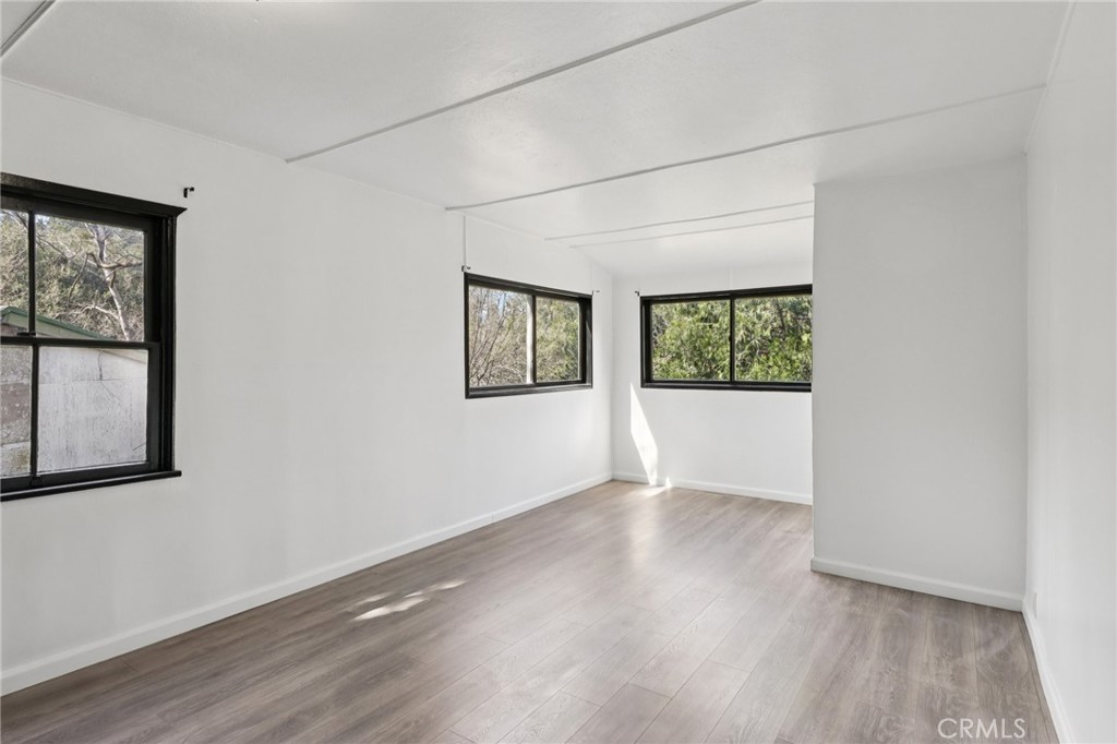 532 Sunset Lane Crestline, CA 92325 - Photo 17 of 41 an empty room with wooden floor and windows