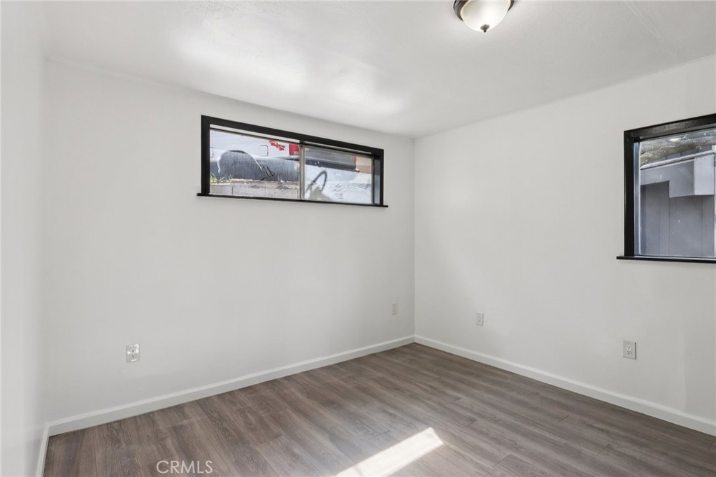 532 Sunset Lane Crestline, CA 92325 - Photo 19 of 41 an empty room with wooden floor and windows