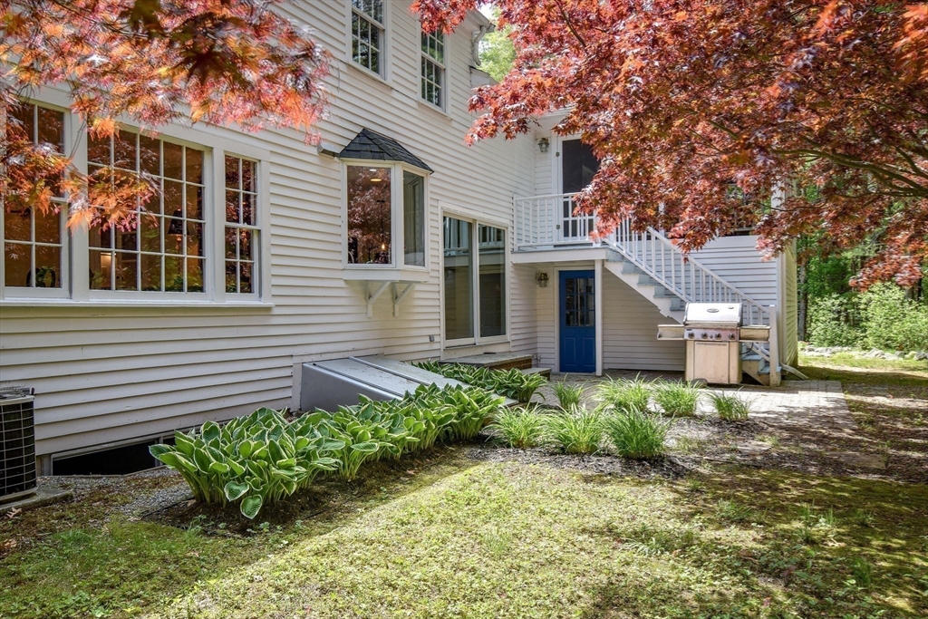114 Hunters Ridge Road Concord, MA 01742 - Photo 29 of 38 a front view of a house with a yard and potted plants