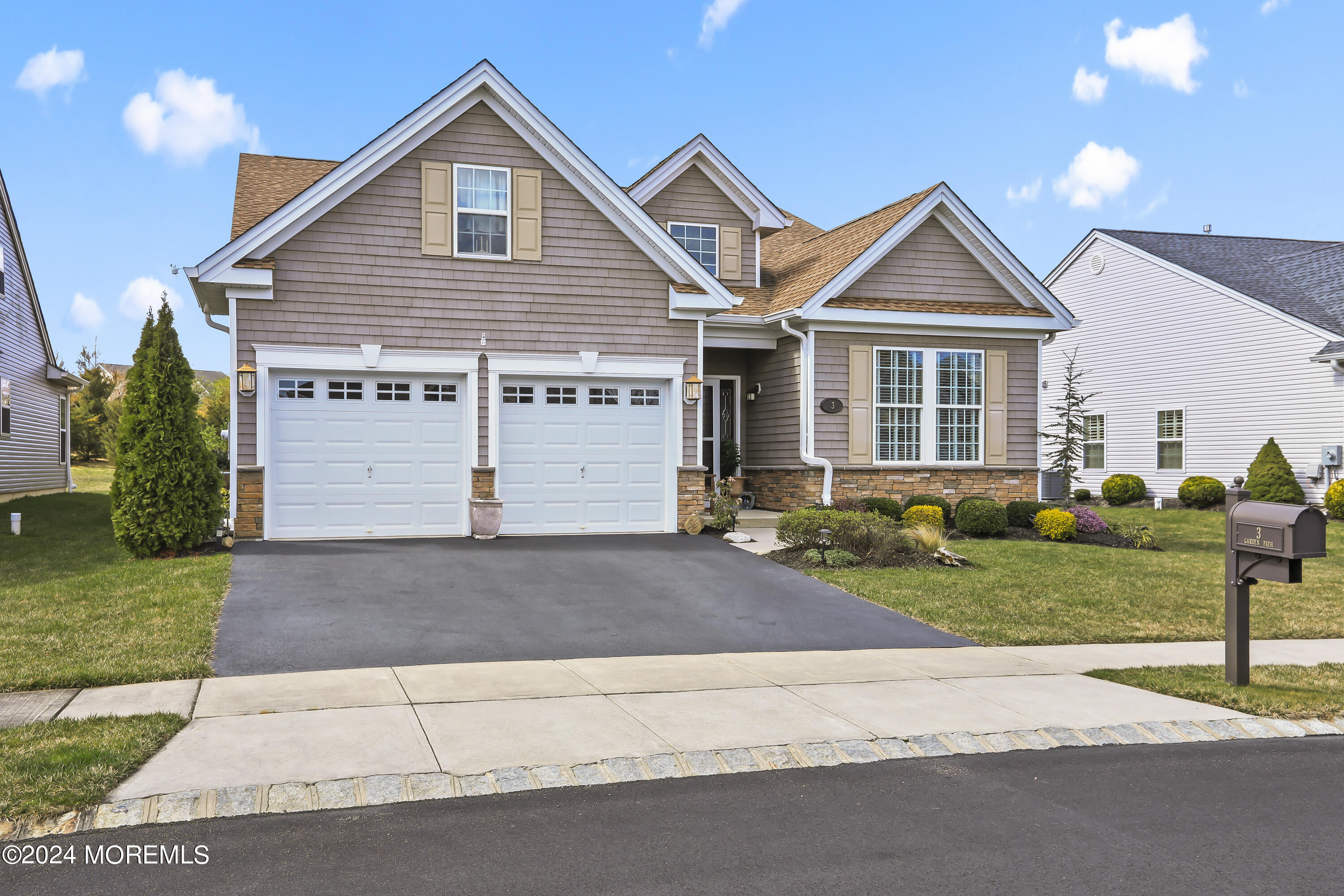 a front view of a house with a yard and garage
