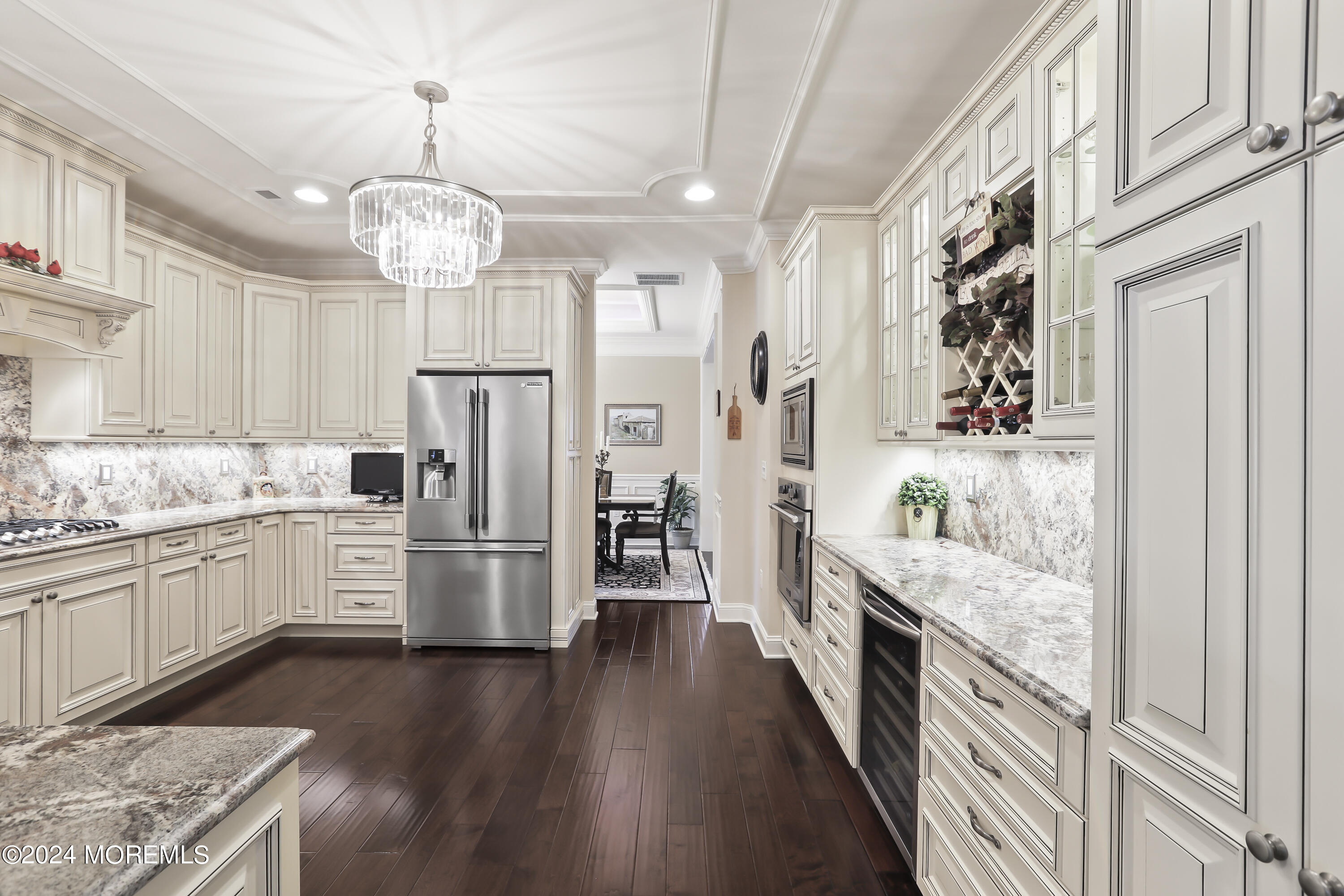 3 Garden Path Barnegat, NJ 08005 - Photo 14 of 59 a large kitchen with stainless steel appliances granite countertop a refrigerator a stove oven a sink dishwasher a dining table and chairs with wooden floor