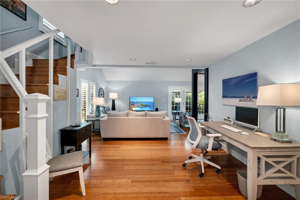 1269 Solana Road, Unit E3 Naples, FL 34103 - Photo 11 of 23 a living room with furniture a fireplace and a flat screen tv