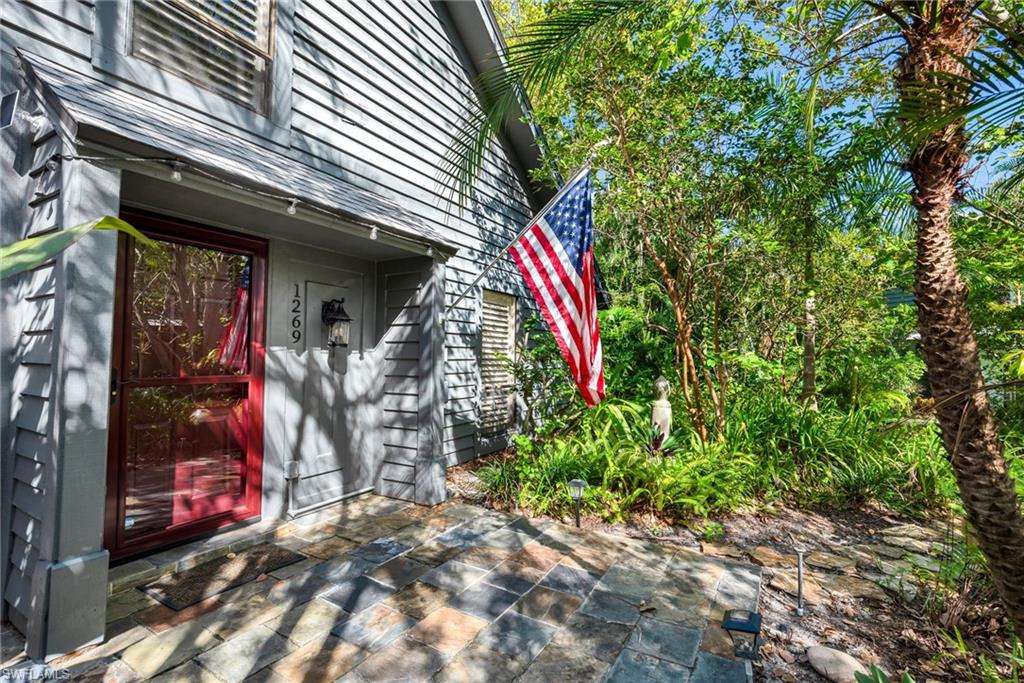 1269 Solana Road, Unit E3 Naples, FL 34103 - Photo 17 of 23 a view of a house with lots of trees and flowers