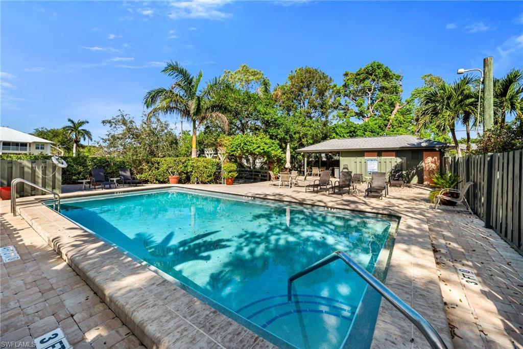 1269 Solana Road, Unit E3 Naples, FL 34103 - Photo 21 of 23 a view of a swimming pool with a patio
