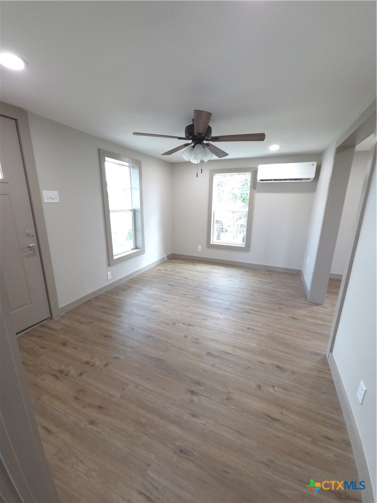 2605 Plainview Street Victoria, TX 77901 - Photo 5 of 16 an empty room with wooden floor and windows