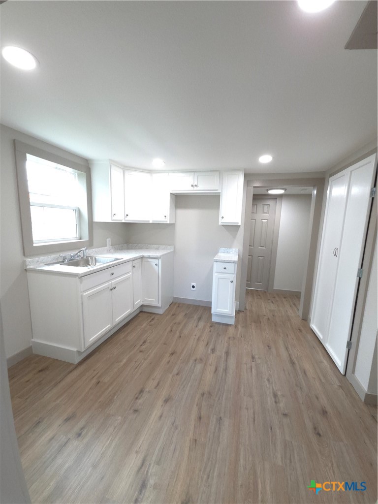 2605 Plainview Street Victoria, TX 77901 - Photo 10 of 16 a large white kitchen with a white wooden cabinets and white appliances