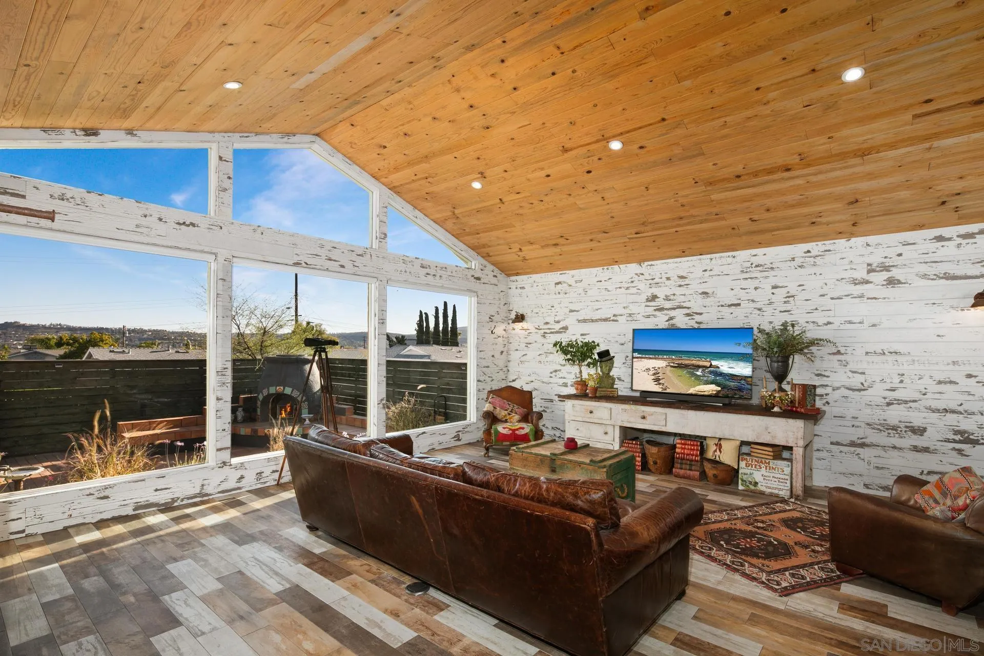 9475 Wharton Road Santee, CA 92071 - Photo 25 of 62 a living room with furniture a flat screen tv and a floor to ceiling window