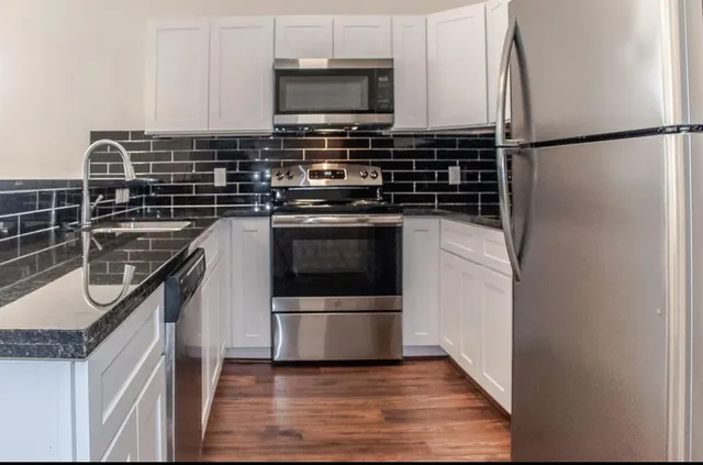 a kitchen with a sink and a stove top oven