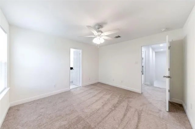 an empty room with fan and a ceiling fan