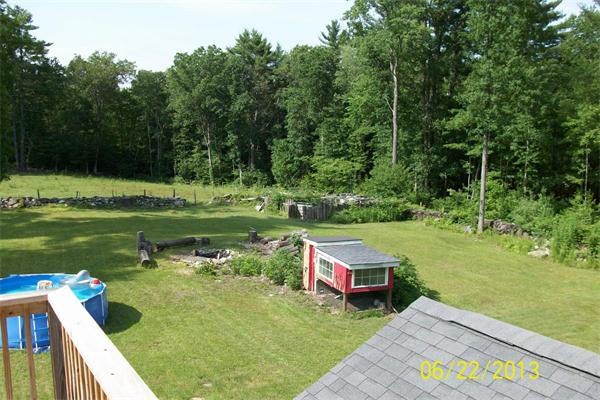 139 Colburn Road Charlton, MA 01507 - Photo 11 of 30 a view of a lake with a yard and sitting area