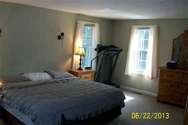 139 Colburn Road Charlton, MA 01507 - Photo 14 of 30 a bedroom with a bed and a flat tv screen on dresser