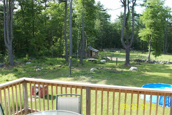 139 Colburn Road Charlton, MA 01507 - Photo 10 of 30 a view of a wooden deck and a yard with swimming pool