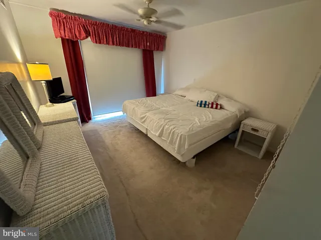 a bedroom with a bed and a mirror