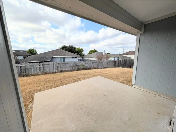 a view of swimming pool with a yard from inside of balcony