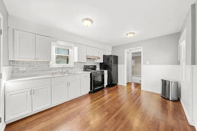 a kitchen with stainless steel appliances a refrigerator sink and cabinets