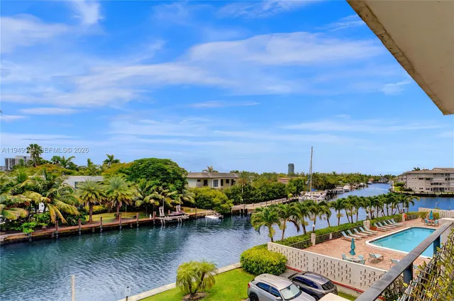 a view of a lake with boats and trees in the background
