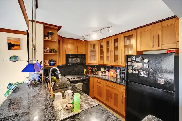 a bathroom with a granite countertop toilet sink and mirror