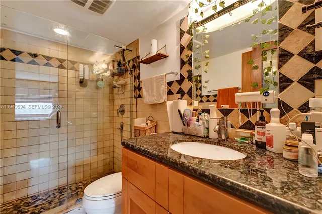 a bathroom with a shower and a sink