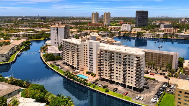 a view of a swimming pool with a lawn chairs and plants
