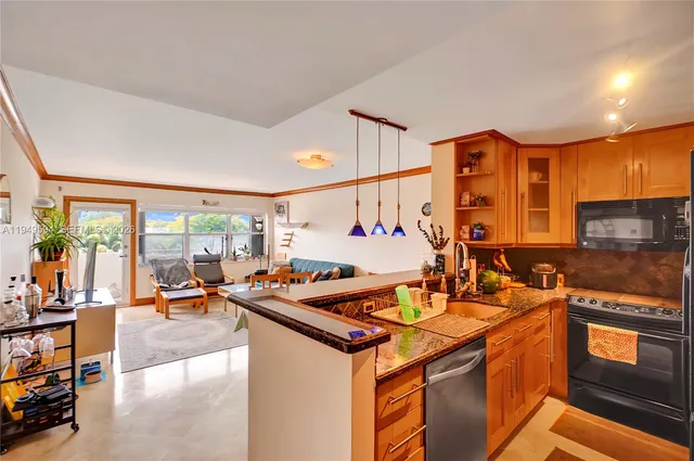 a living room with furniture a rug potted plant and a large window