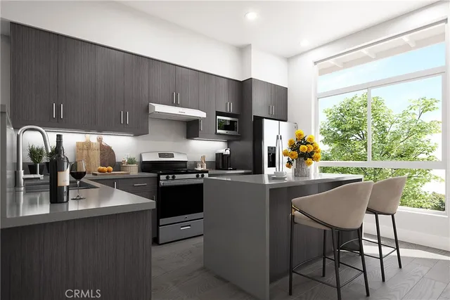 a kitchen with appliances cabinets and a counter top space
