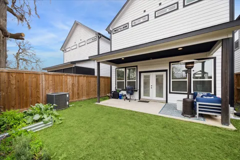a front view of a house with patio and garden