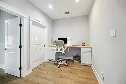 a view of entryway and hall with wooden floor
