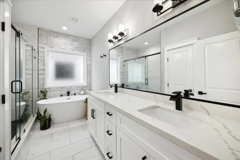 a bedroom with a large bed and a flat tv screen