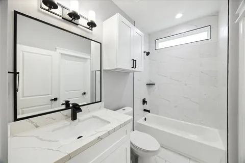 a bedroom with a bed window and a couch