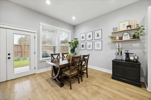 a view of a dining room with furniture and a window