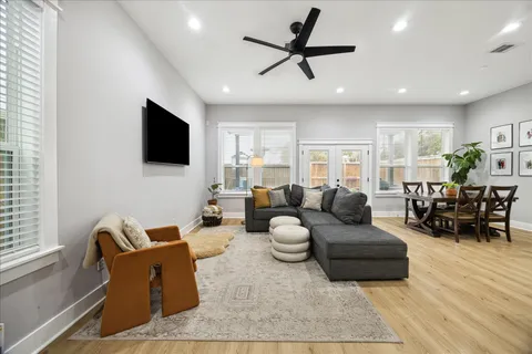 a living room with furniture and a wooden floor