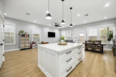 a living room with furniture and kitchen view