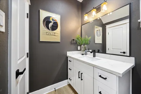 a view of kitchen with stainless steel appliances kitchen island a stove and a wooden floors