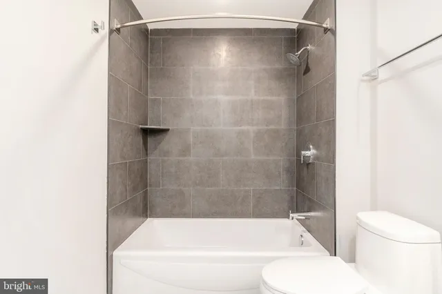 a bathroom with a shower and a toilet