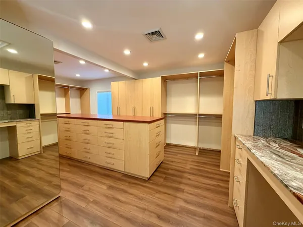a bedroom with a bed and a mirror