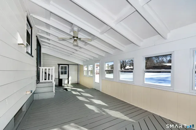 a view of a room with a window and a ceiling fan