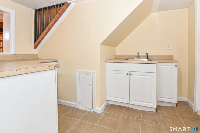 a view of a kitchen with white cabinets
