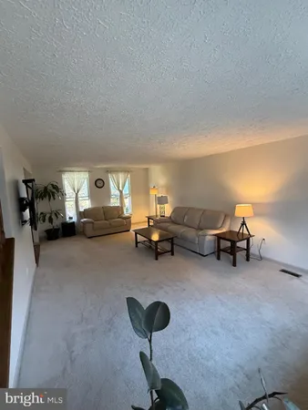 a spacious bedroom with a bed and a dresser