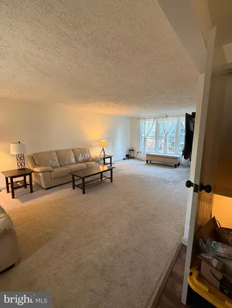 a bedroom with a bed and a mirror on dresser
