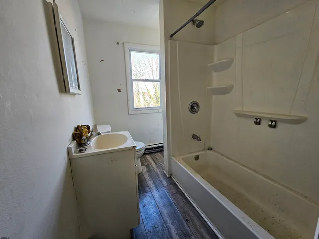 a bathroom with a sink a bathtub and shower