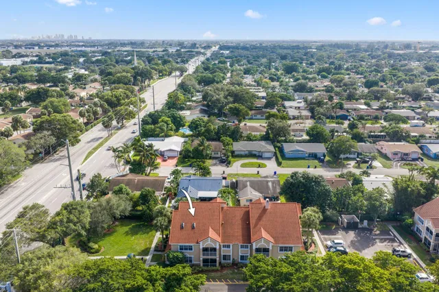 an aerial view of residential houses with outdoor space and swimming pool