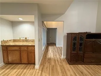 a view of a hallway with wooden floor and closet