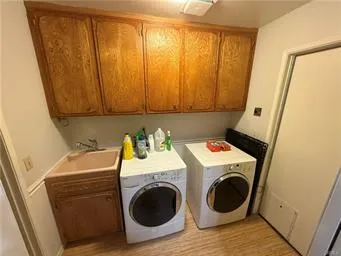 a utility room with a sink a washer and dryer