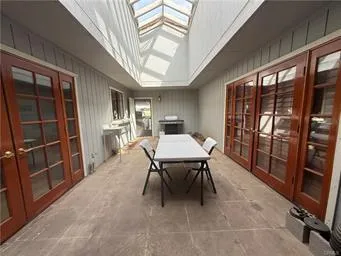 a view of a hallway with furniture and gym equipment